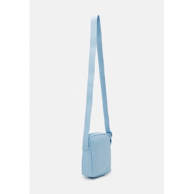 Lacoste UNISEX EXCLUSIVE - Across body bag - light blue